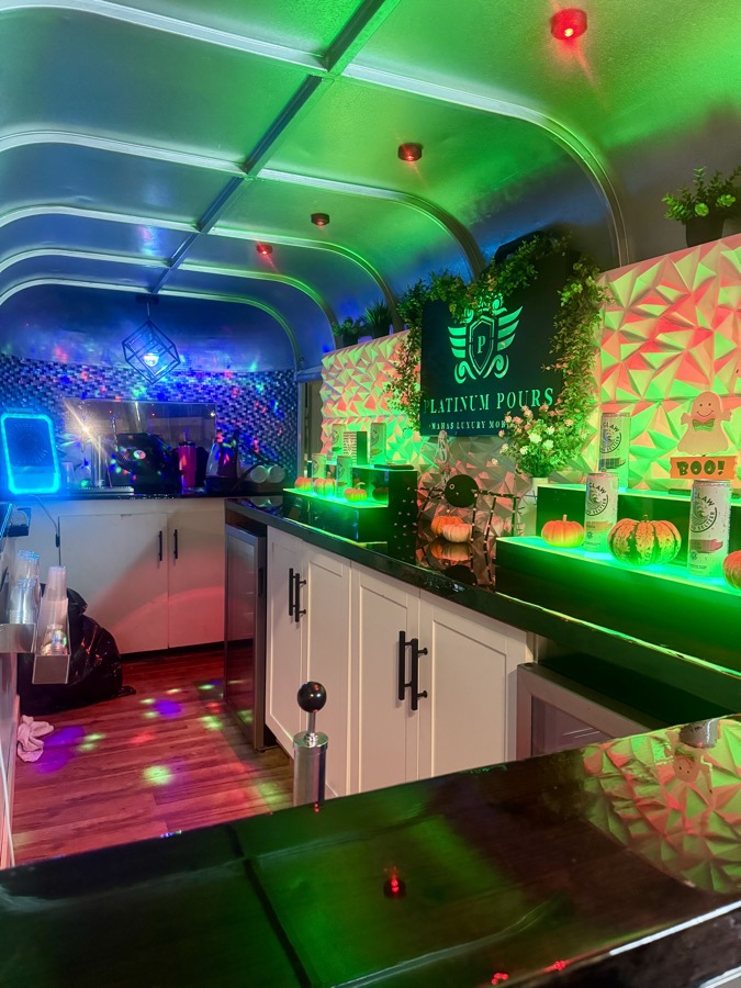Detail of the Jackpot trailer's LED-lit interior with the Platinum Pours backsplash and greenery