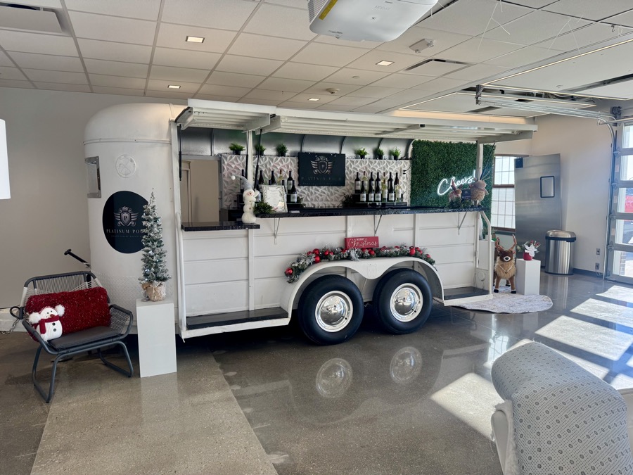 Holiday-themed Jackpot setup with a smiling snowman, evergreen accents and Christmas signage
