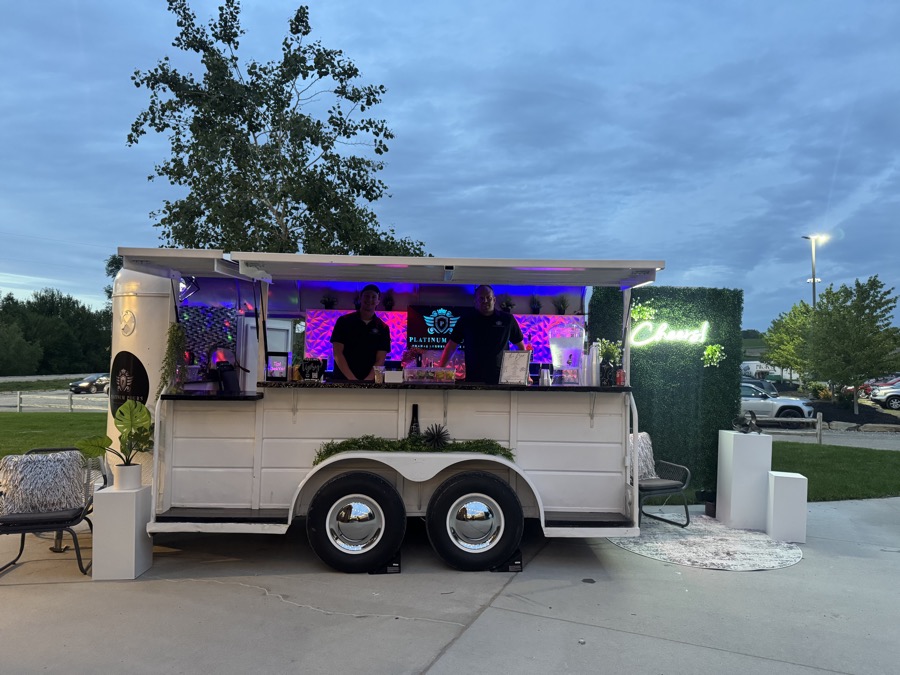 Jackpot bar trailer at dusk with purple and red LED interior lighting