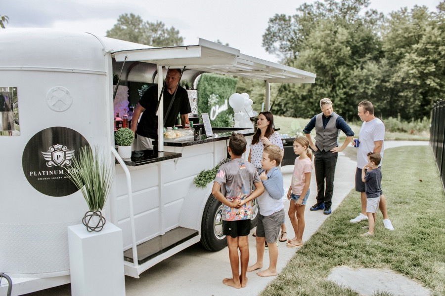 Jackpot bar trailer styled with floral LOVE letters at a wedding