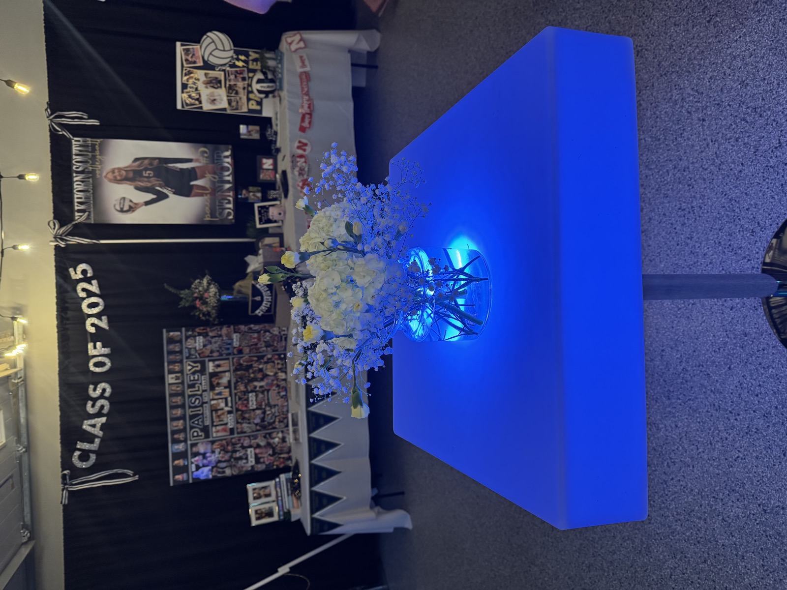 LED-lit high-top cocktail table glowing blue at an evening event